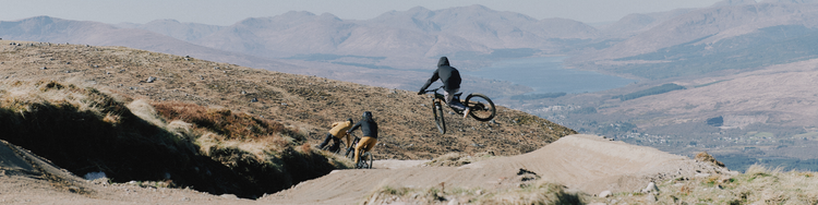 Three people cycling in the mountains