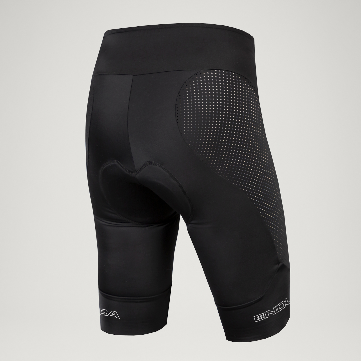 Black cycling shorts with mesh design and padding on a light gray background