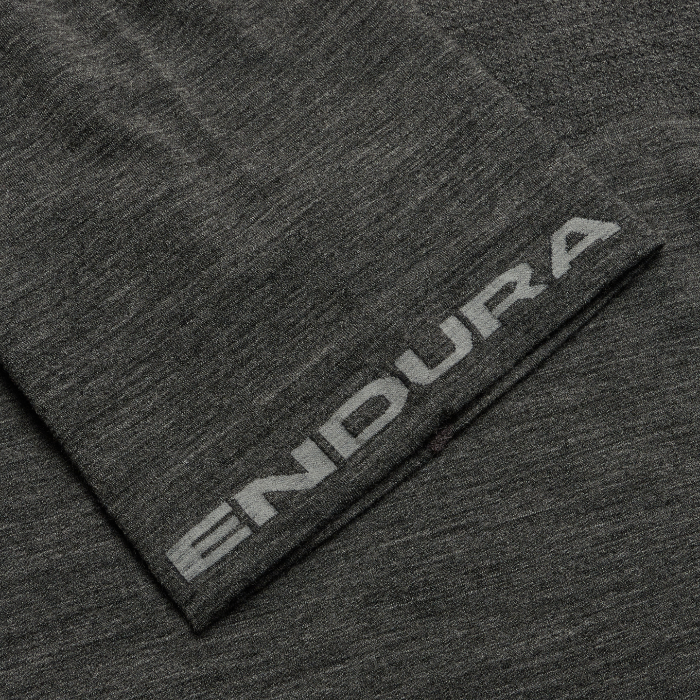 Close-up of a dark gray fabric with 'Endura' branding.
